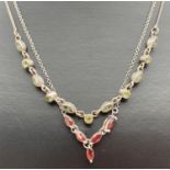 2 silver stone set necklaces. One set with 6 marquise cut and 5 round cut peridot stones. The