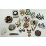 A collection of 17 vintage and modern costume jewellery brooches and scarf clips. In varying designs