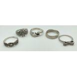 5 silver dress rings, some stone set. A band ring with horse head and hoof detail, an owl ring