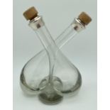 A silver collared double crossover oil/vinegar bottle with cork stoppers by P.H. Vogel & Co,