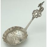An antique Dutch silver tea caddy spoon with hooked handle. Bowl has scalloped rim and a