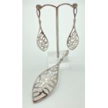 A large silver leaf design, pierced work teardrop shaped pendant with matching drop earrings. All