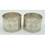 A pair of heavy silver napkin rings, engraved with Home & Henderson Clan crests. Fully hallmarked
