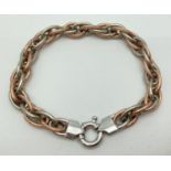 A 9ct duo coloured gold large link rope style bracelet with large spring clasp. Rope chain made up