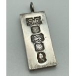 A large vintage silver ingot commemorative pendant with hallmark detail to front. Hallmarked