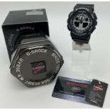 A G-Shock 5081 wristwatch with black silicone case and strap. White face with both analogue and