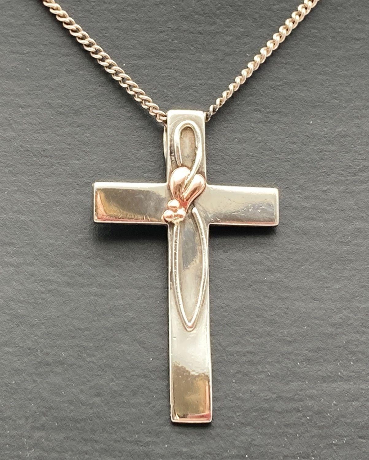 A silver and Welsh gold accent Clogau cross pendant on an 18 inch curb chain. Pendant marked "