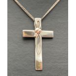 A silver and Welsh gold accent Clogau cross pendant on an 18 inch curb chain. Pendant marked "