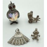 4 vintage silver and white metal charms. A small Imp, a fan, a rickshaw and an owl with crystal body