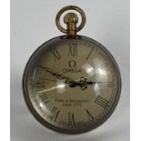 A brass bound, desk top glass ball watch with Roman numeral markers. Top winding, in working