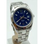A men's Timex Indiglo wristwatch with stainless steel bracelet strap. Stainless steel case with blue