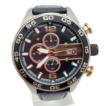 A men's CH-2559 chronograph wristwatch by Fossil with black leather strap. Black face with rose gold