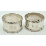 A pair of William Hutton & sons Victorian silver 'his and hers' napkin rings. Engraved monograms '