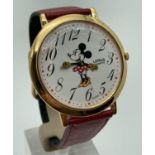 A Disney Minnie Mouse quartz wristwatch with red leather strap. Minnie's hands are the hour and