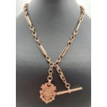 A late 19th century 9ct gold albert watch chain with decorative monogrammed fob. T bar, lobster