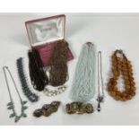 A quantity of assorted vintage glass & plastic beaded necklaces & bracelets.
