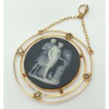 An antique Wedgwood black jasperware & 14ct gold cameo style pendant with seed pearl detail.