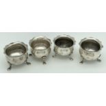 A set of 4 Walker & Hall Victorian silver 3 footed salts with scalloped shaped rims. Of bulbous form