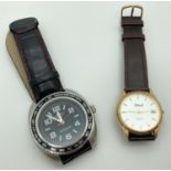 2 men's wristwatches. A Wingmaster London watch with black leather strap and luminous hands, in