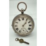 An early 20th century silver cased pocket watch, in working order, complete with key. Enamelled face