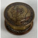 A small metal pill box made from a brass nut and 2 1935 George VI vintage penny coins. Approx. 3cm