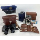 A collection of assorted items to include binoculars, cameras and military cap. Lot includes cased