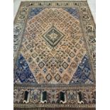 A vintage Persian style wool rug of brown (faded red), blue, green & black colouration. Shows