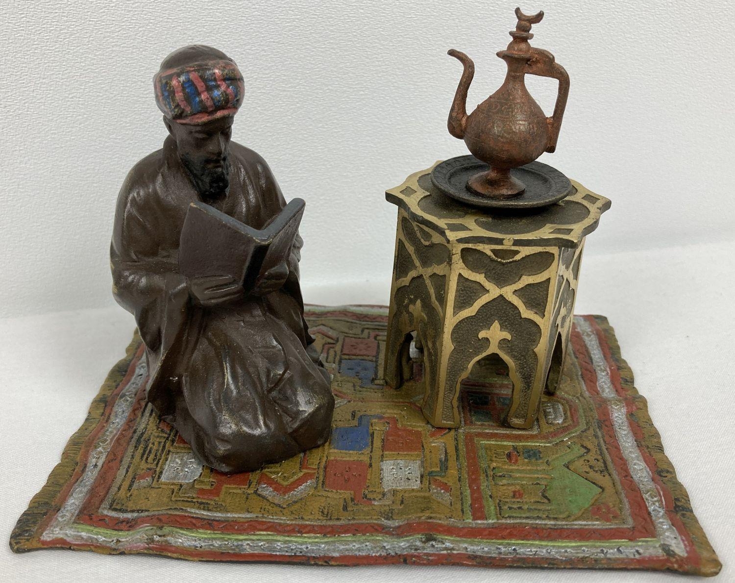 After Bergman - a cold painted Arabian style inkwell. An Arabian gentleman knelt reading on a