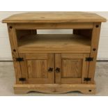 A modern Corona style pine TV/media corner unit with black metal stud detail and round drop handles.