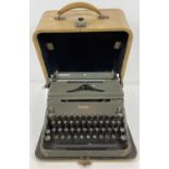 A dark green finish Hermes 2000 typewriter in hard carry case.