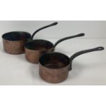 A set of 3 vintage graduating French copper saucepans with riveted handles. Largest approx. 16cm