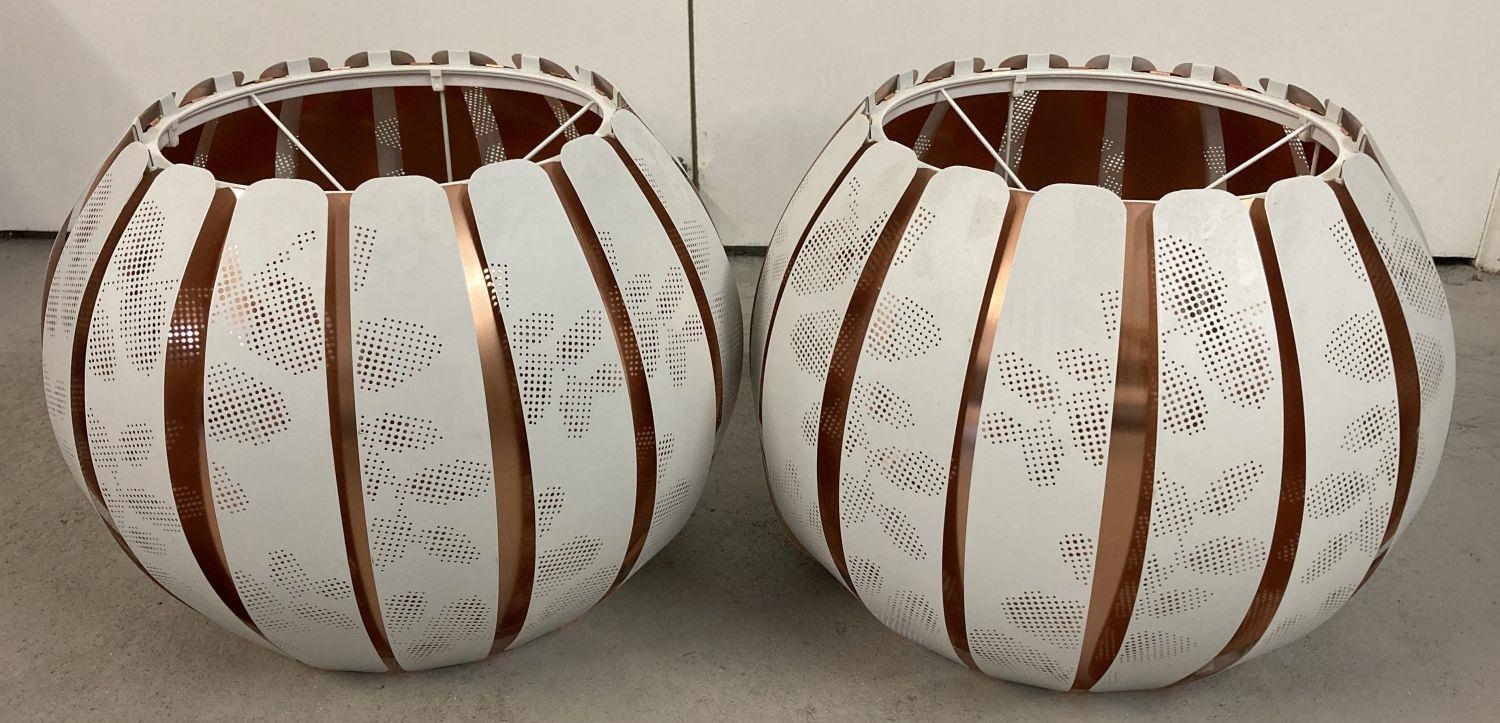 A pair of modern copper and white patterned metal globe style ceiling light shades. Approx. 30cm