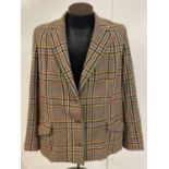 A ladies tweed jacket with button fastening by E. Abington & Sons Ltd, Kimbolton. In tan, red, black