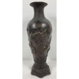 A Chinese bronze vase with dragon design and hexagonal shaped metal base. Impressed mark to