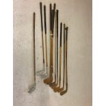 A collection of hickory handled vintage golf clubs to include putters and irons. Examples include