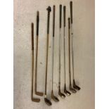 A collection of vintage golf drivers and putters in varying conditions. To include J. P. Cockrane