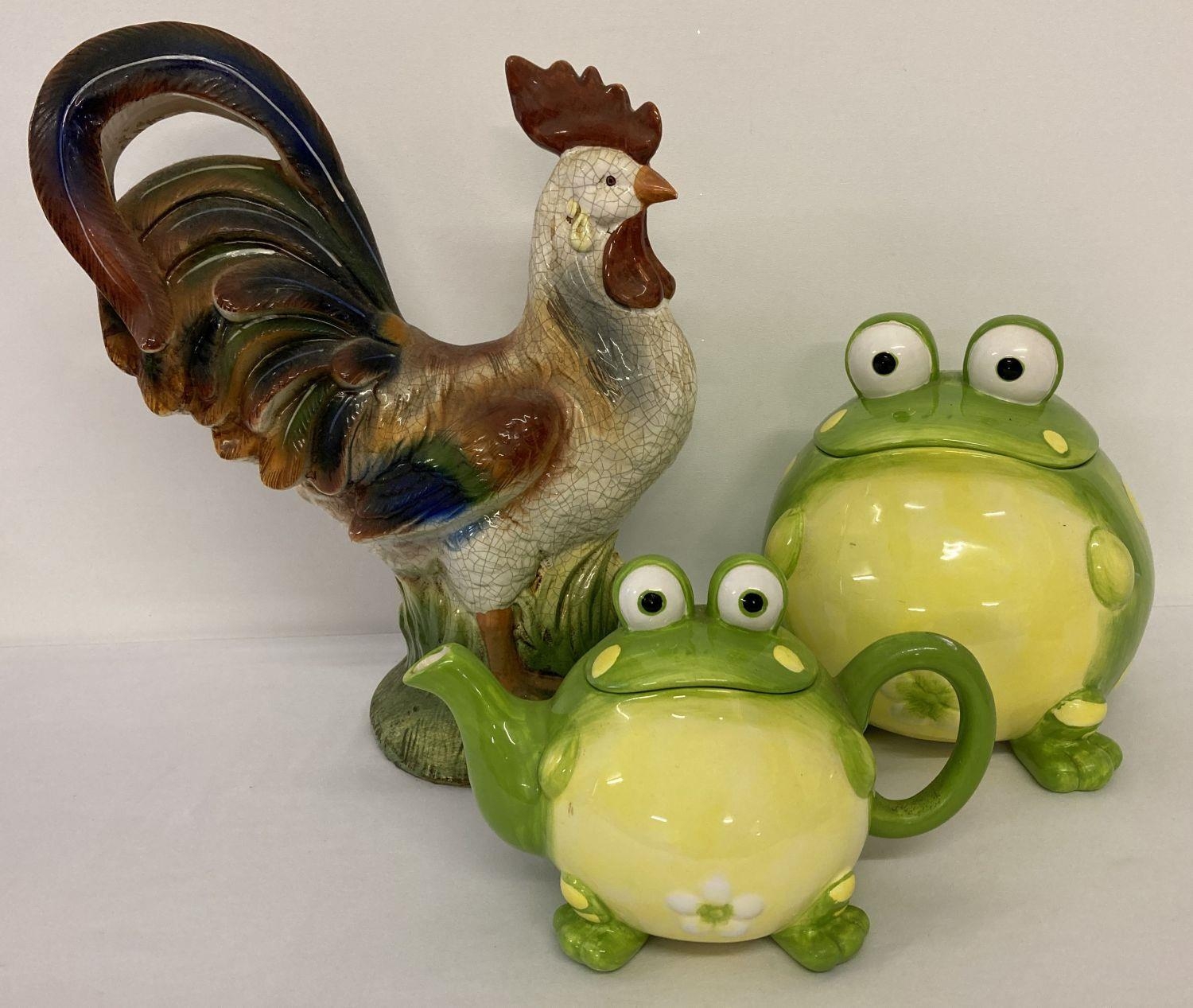 A large painted ceramic cockerel figurine together with a modern ceramic biscuit barrel and teapot