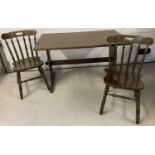 A dark wood refectory table together with 2 dark wood farmhouse style chairs.