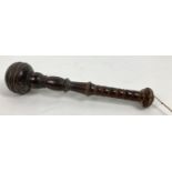 An early 20th century dark wood truncheon with bulbous head and turned detail. Approx. 33 cm long.