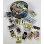 A tin of assorted vintage Brooke Bond tea cards & Black Cat Craven cigarette cards.