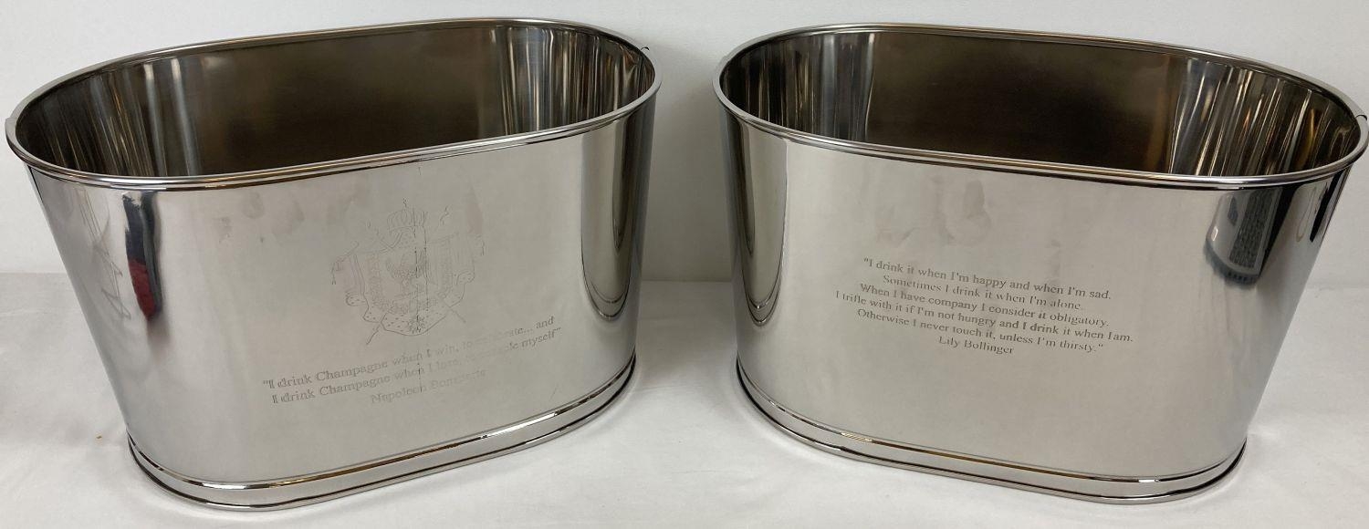 A pair of large Bollinger Champagne buckets with engraved details to sides. One side is engraved