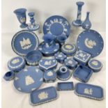 A large of assorted Wedgwood blue & white Jasper ware ceramics. To include: plates, vases, lidded