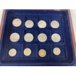 A wooden coin display box with blue baize lined interior & contents. Contents comprise 8 x