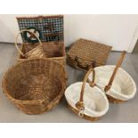 A collection of wicker items. Comprising: a picnic basket with 2 plates, knives and fork and