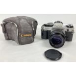A Canon AE-1 Program camera with Hoya Skylight Canon Lens FD 50mm 1:1.4 and cover case. The cover