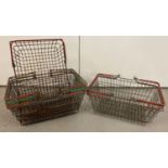 6 vintage wire shopping baskets with red and green plastic grip handles.