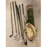A vintage canvas pencil golf bag with a 6 vintage golf clubs (and 1 club handle) to include Willie