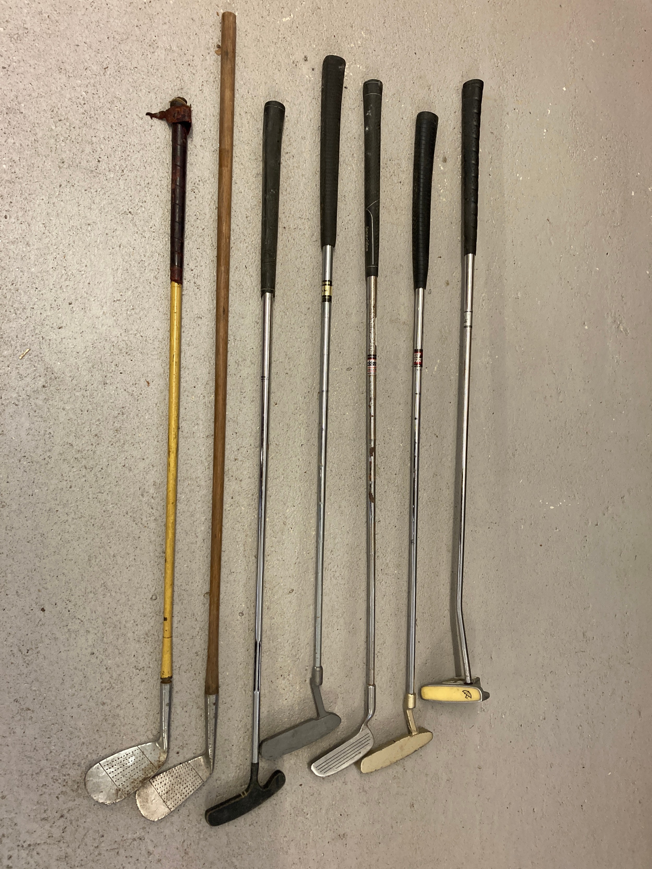 A collection of vintage golf putters and irons in varying conditions. To include Bay Hill by