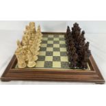 A vintage wooden & brass chess board together with a quantity of Duke of Wellington chess pieces.