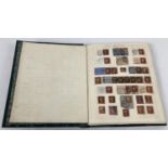 A vintage green stamp album containing a quantity of Victorian & vintage world stamps to include